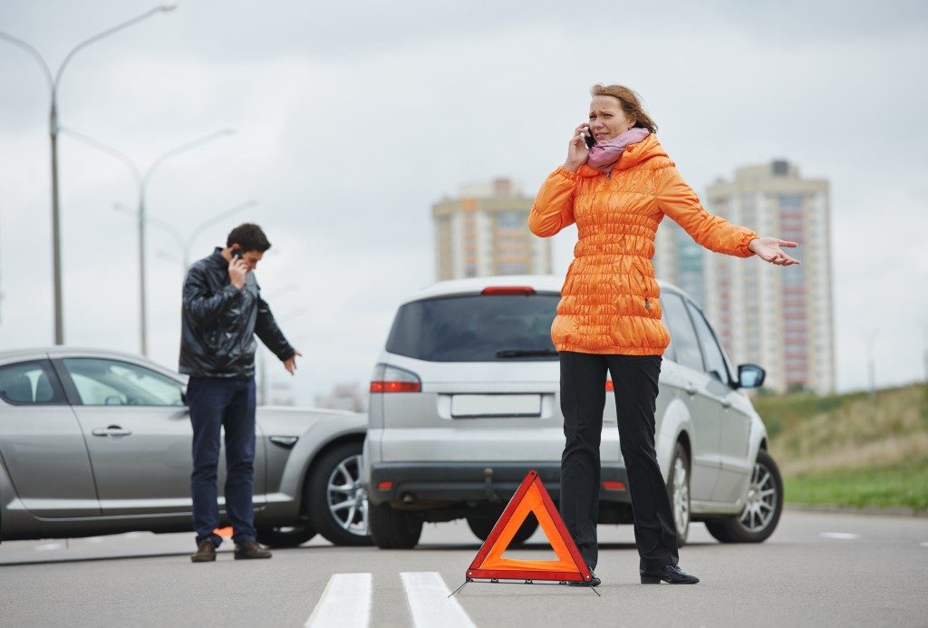 woman calling after car accident on the road