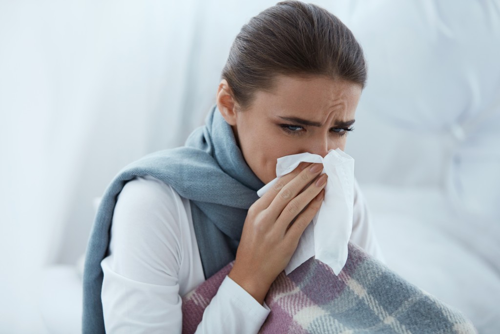 Female with colds blowing her nose