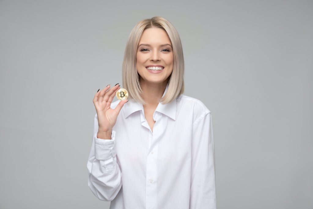 woman holding a gold coin