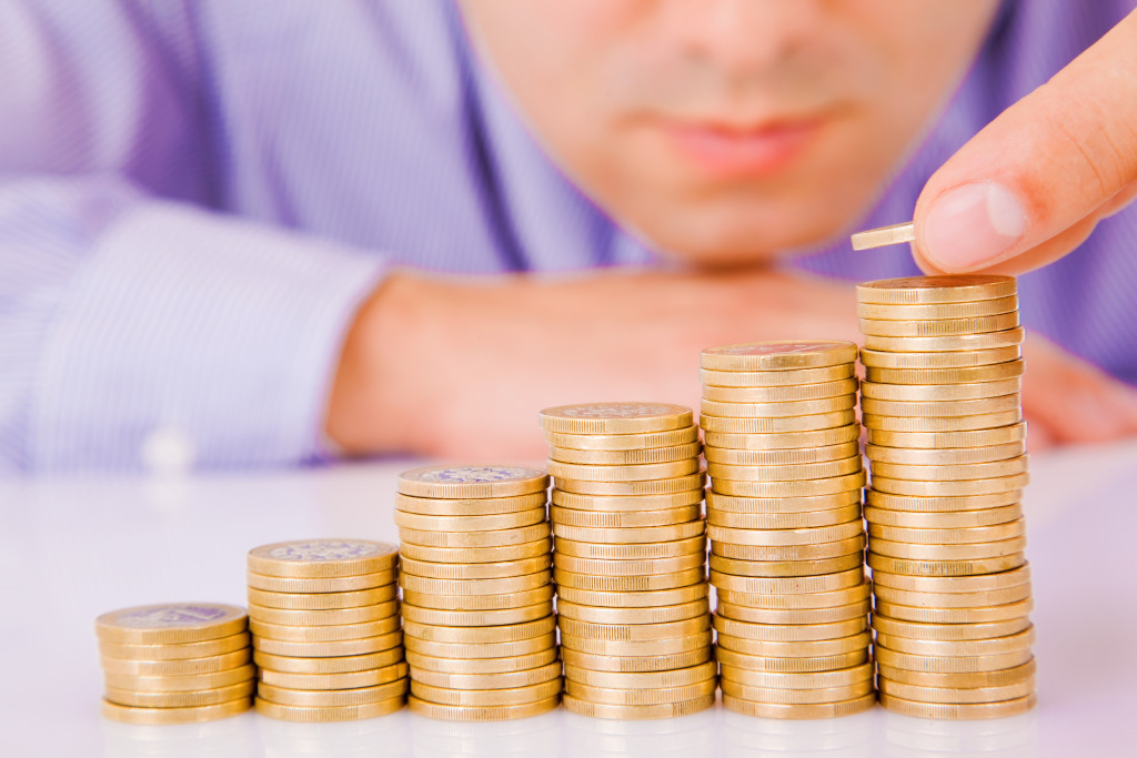 man stacking up coins