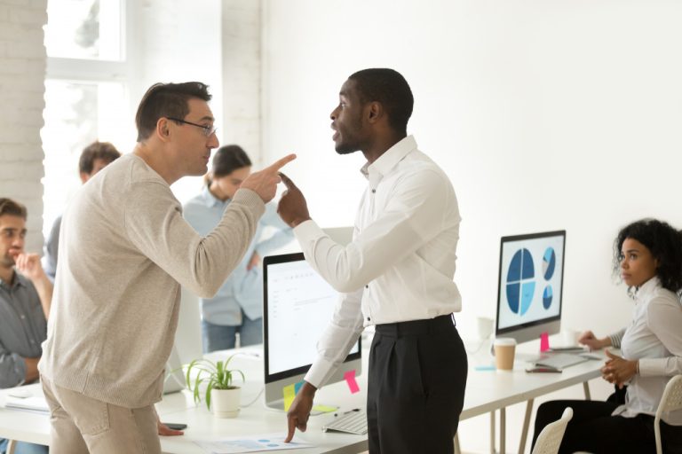 multiracial employees arguing in the workplace