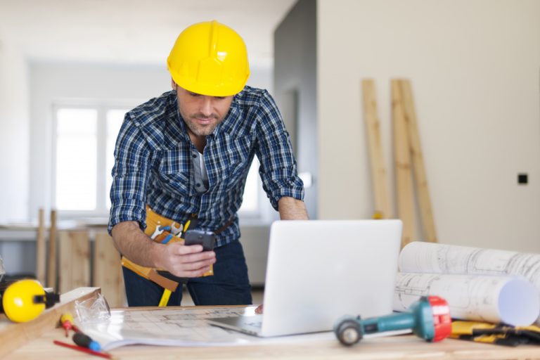 busy man wearing a yellow hard hat