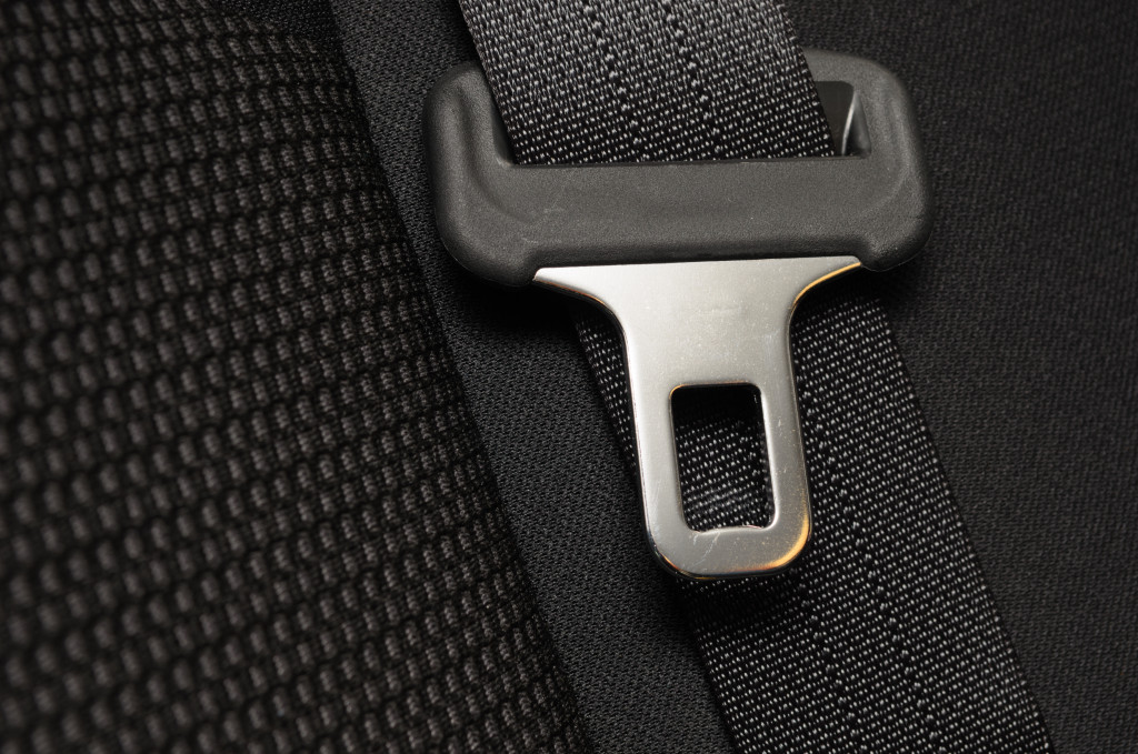 A seat belt buckle on a seat cover texture