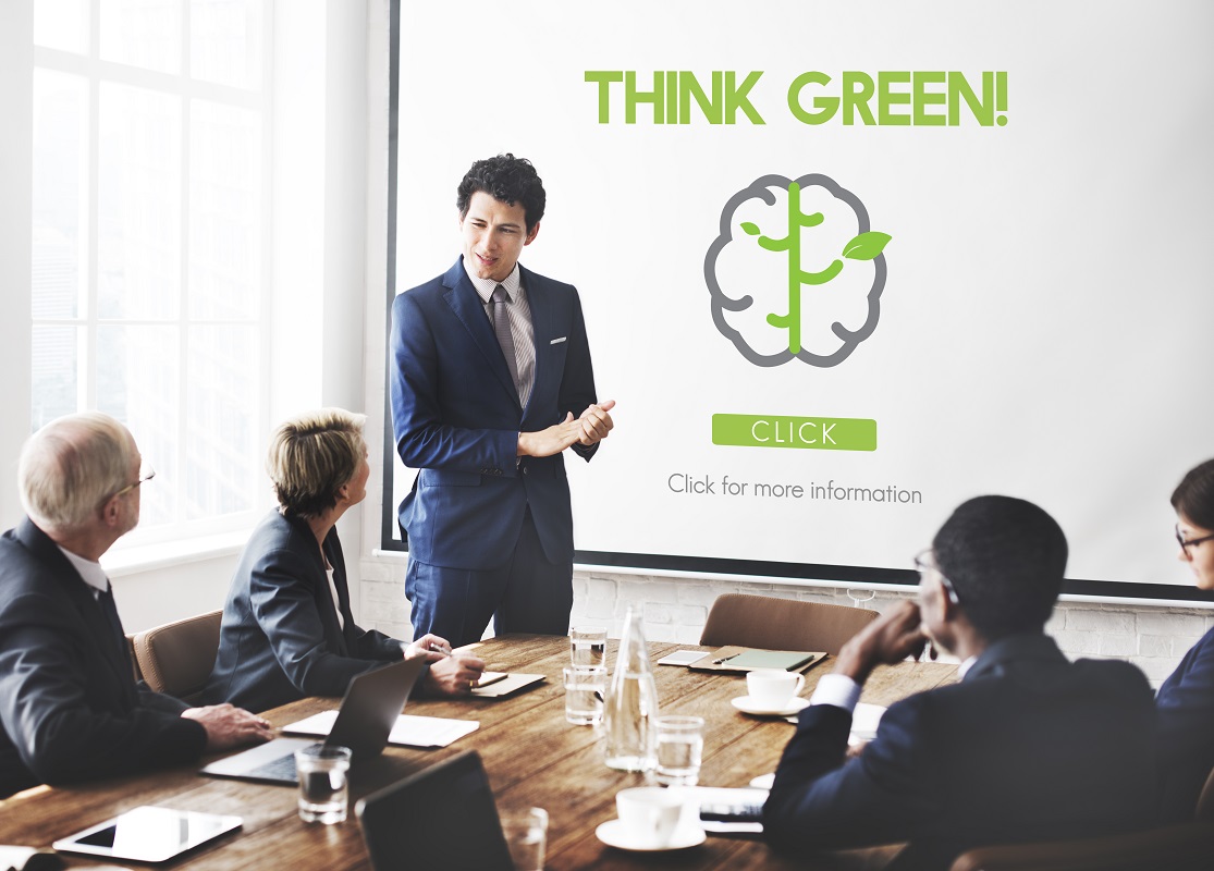 A businessman presenting a THINK GREEN! concept