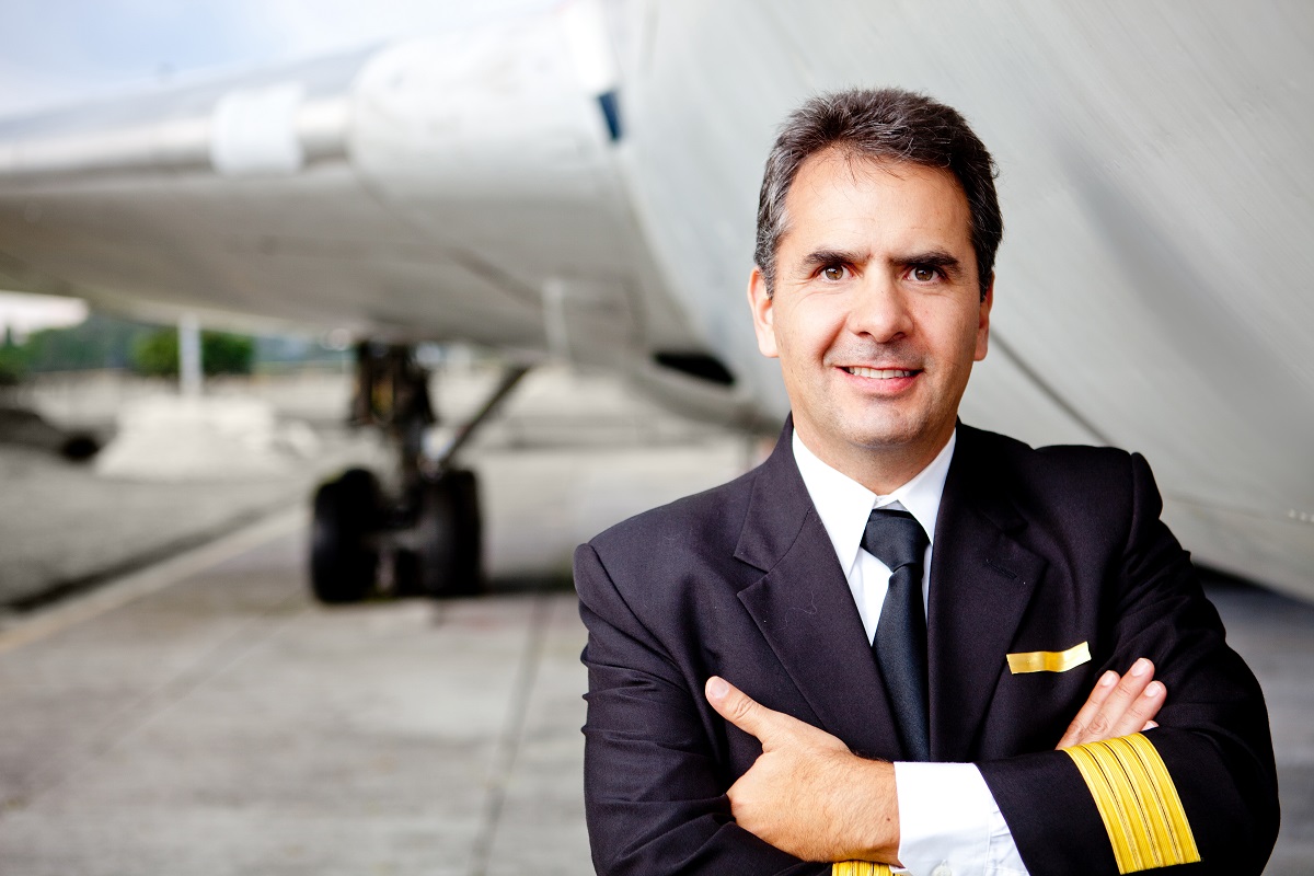 an old man smiling with airplane on the background